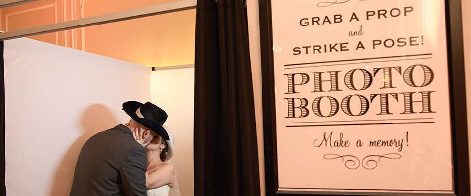 Bride and groom kissing in a photo booth