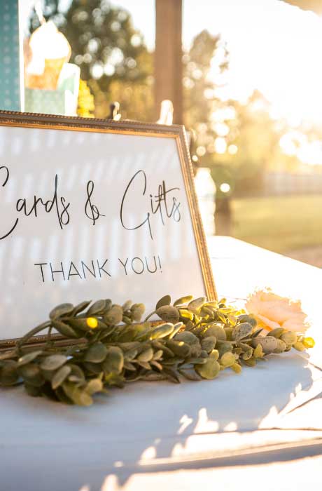 A wedding wooden sign letting guest know where to put the cards. 