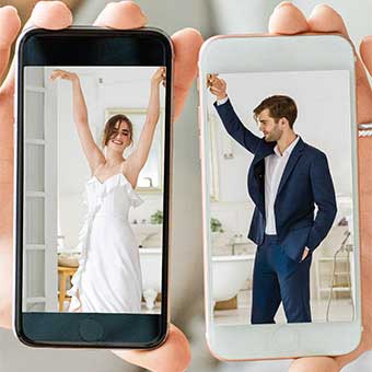 Two iPhones held together to show a bride and groom dancing.