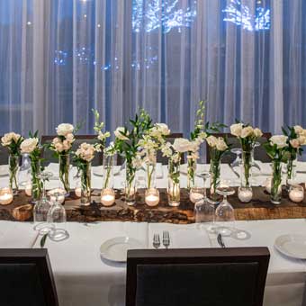 A table setup with flower decor in center of table. 