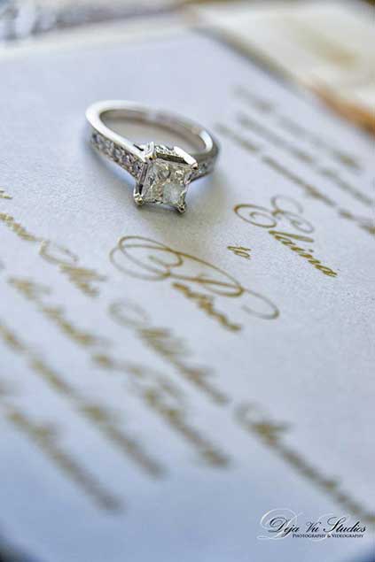 Engagement ring on wedding invitation