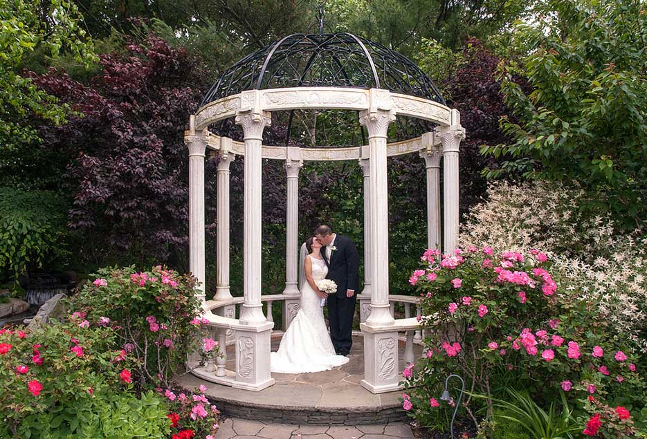 Bride and Groom kissing in the gazebo. 