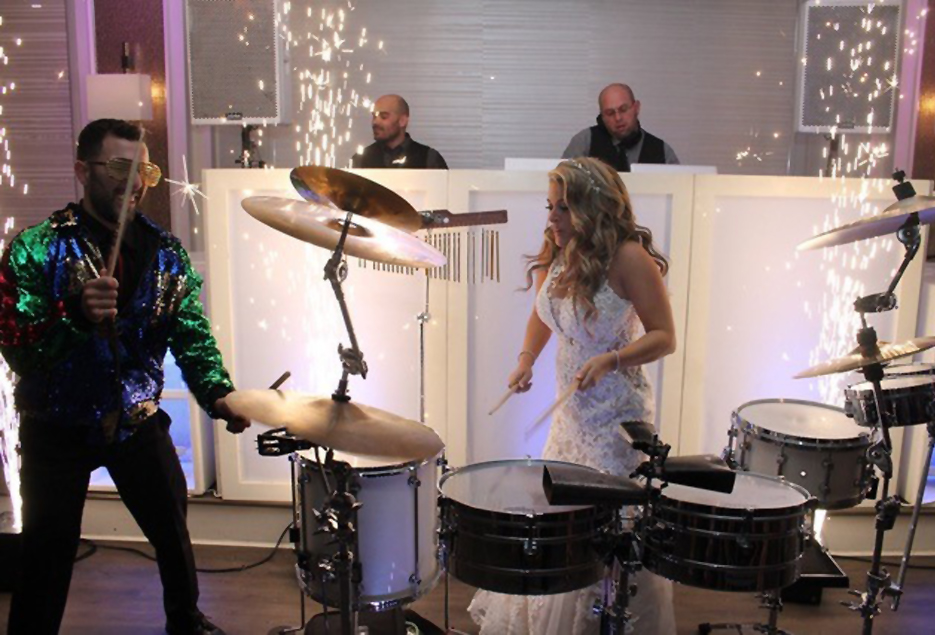 Bride plays drums alongside LI Sound DJ drummer.