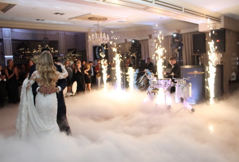 Bride and groom dance in a cloud of fog and sparkler machines at Giorgios.