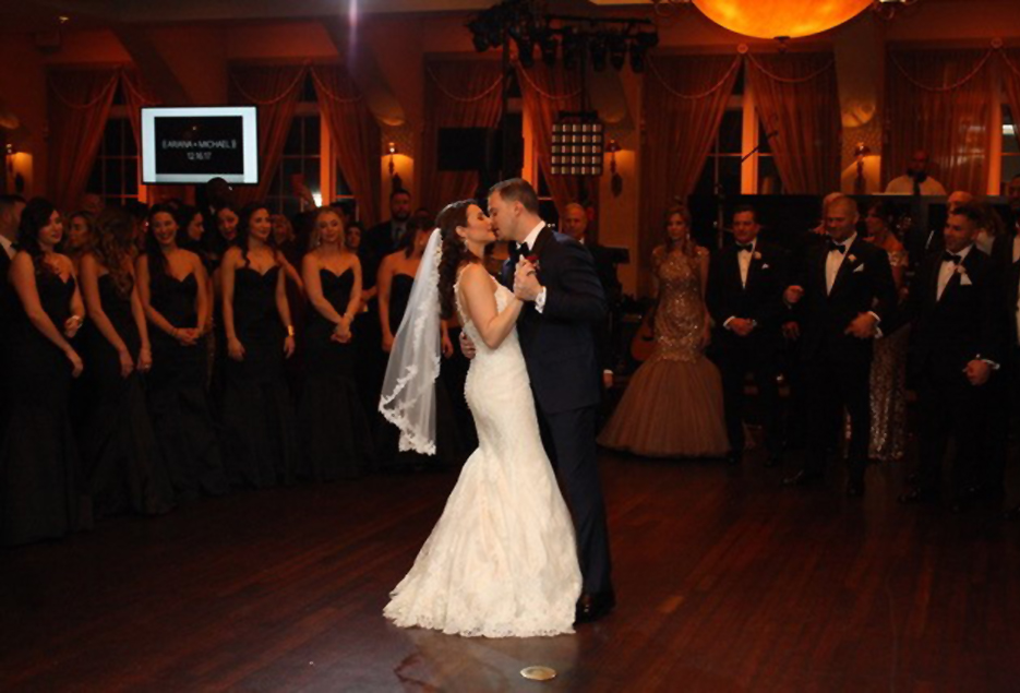 Bride and groom kiss while doing their first dance.