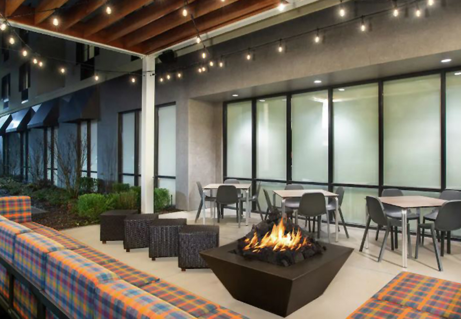 Outdoor patio area with seating areas and fire pit.