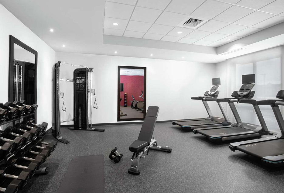 Gym with treadmills, weights, and other workout equipment.
