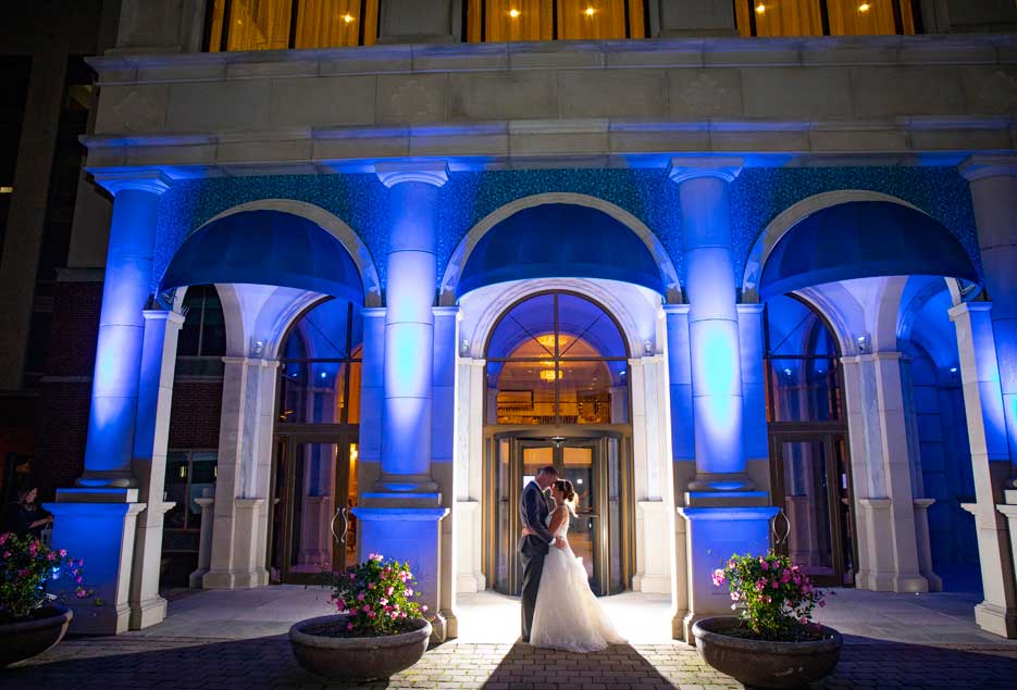 Bridal couple embracing outside the front of the Atlantis Banquet Events. 