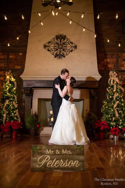 Bride and groom kissing in front of the fireplace at Riviera Waterfront Mansion. 