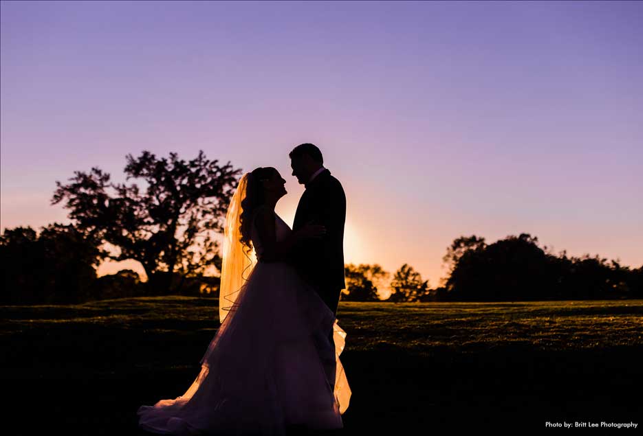 Couple silhouette image on the golf course of the Village Club at Lake Success. 