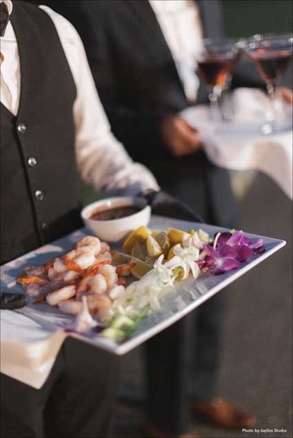 Waiter holding a tray of shrimp for the guests at The Village Club at Lake Success. 