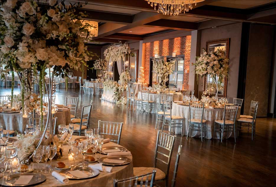 Village Club at Lake Success wedding reception setup with tall white flower centerpieces. 