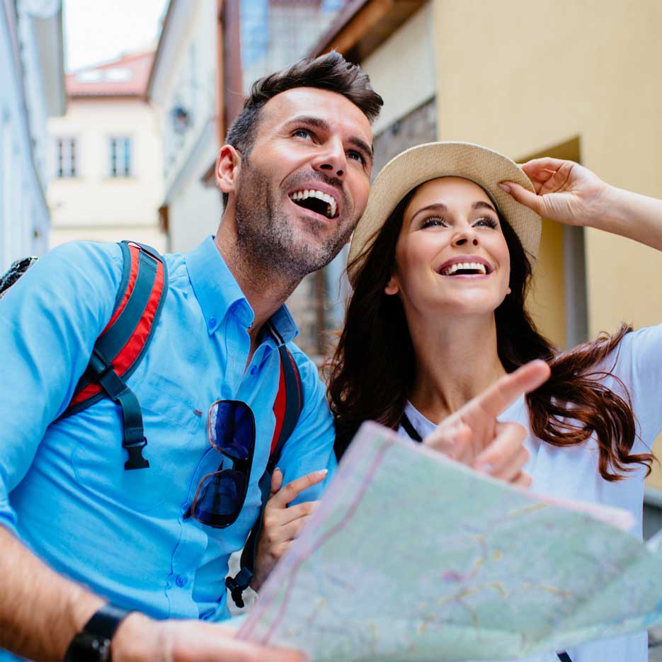 Couple on a honeymoon looking at a map. 